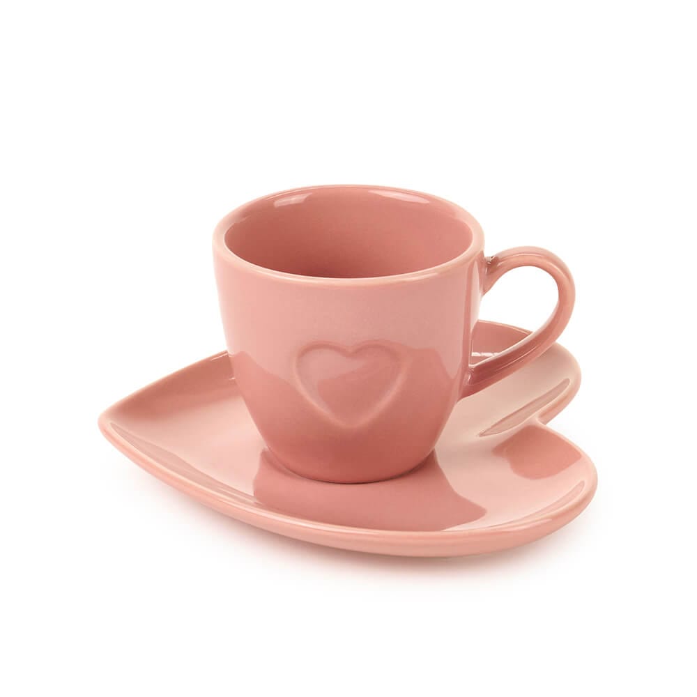 Tazzina da caffè in porcellana rosa con cuore in rilievo e piattino a forma di cuore, ideale per pause caffè eleganti o romantiche.