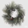 Corona decorativa EDG con aghi lunghi di pino innevati e pigne marroni, su base intrecciata naturale, diametro 50 cm.