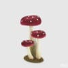 Decorazione composta da tre funghi in tessuto rosso con pois bianchi e gambo chiaro, su base naturale effetto muschio.