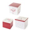 Set di tre scatole regalo natalizie quadrate con decorazioni a tema La Giostra di Amelie: cavalli, fiocchi, cuori e righe colorate.
