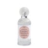 Flacone in vetro trasparente decorato con tappo zigrinato e etichetta rosa del profumo per tessuti Mathilde M Bouquet Précieux da 75 ml.