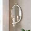 Specchio ovale in ferro color crema anticato con portacandela Chic Antique, montato a parete.
