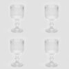 Set de 4 gobelets en verre transparent avec rayures verticales et base travaillée, style rétro élégant.