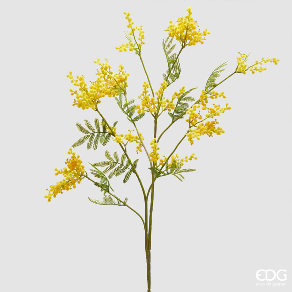 EDG Ramo Mimosa artificiale H 111 cm 1 Ramo di mimosa artificiale giallo EDG con piccoli fiori soffici e foglie verdi, stile naturale e decorativo.