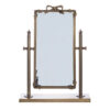 Miroir de table avec base rectangulaire, cadre en métal antique et noeud décoratif en haut.