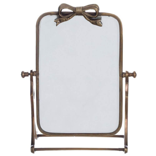 Espejo de mesa rectangular con marco de metal bronceado y lazo decorativo en la parte superior. Marco basculante. 