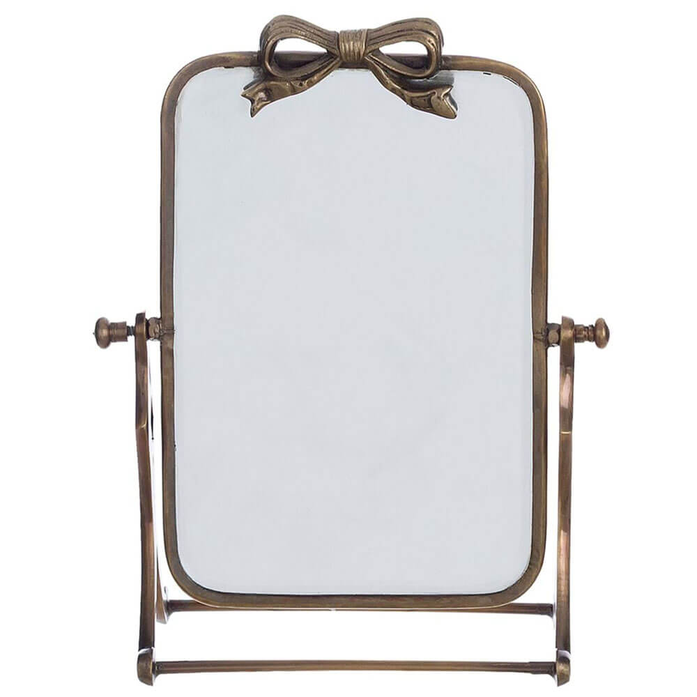 Espejo de mesa rectangular con marco de metal bronceado y lazo decorativo en la parte superior. Marco basculante.