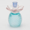 Portacandela in vetro lilla e azzurro con base decorata a rilievo e fiore scolpito, design reversibile.