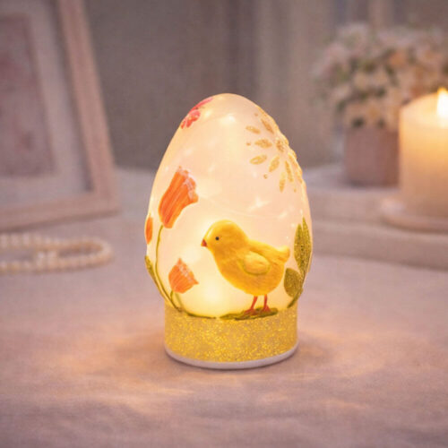 Décoration en verre en forme d'œuf de Pâques avec poussin jaune, fleurs et base pailletée avec lumière LED.