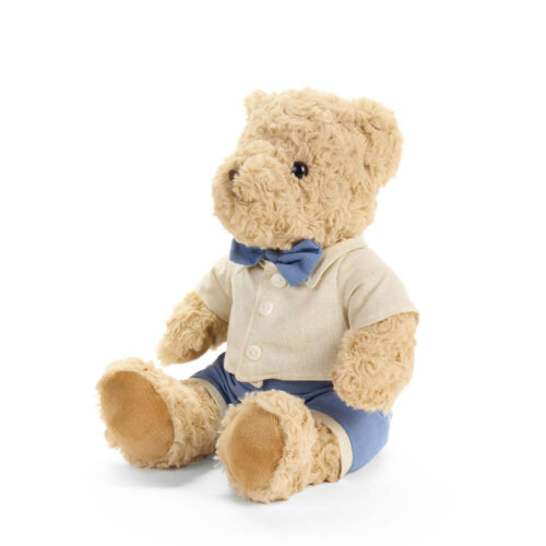 Peluche Sweet Bear de 25 cm Nuvole di Stoffa, de color beige, sentado y vestido con camisa crema, pajarita azul y pantalones cortos azules.