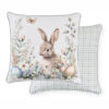 Cuscino arredo double face Nuvole di Stoffa con coniglietto, farfalla e fiori pasquali su fondo chiaro e retro a quadretti verde salvia.