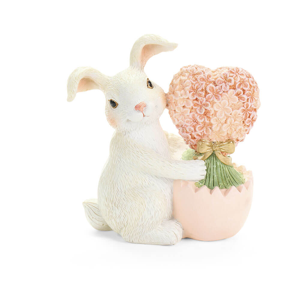 Lapin décoratif en résine avec arbre en forme de coeur rose et base en coquille d'oeuf pastel.