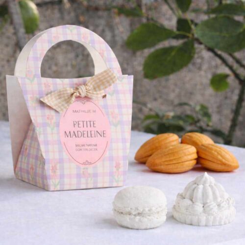 Set Mathilde M Petite Madeleine con 2 decoraciones perfumadas de tiza blanca (macaron y mignardise) en un paquete shopper a cuadros pastel con lazo.