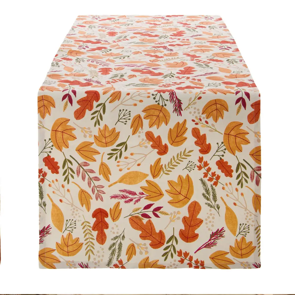 Runner da tavola Blanc Mariclò Bosco Ambrato con stampa di foglie autunnali multicolore su fondo chiaro, misura 45x140 cm.