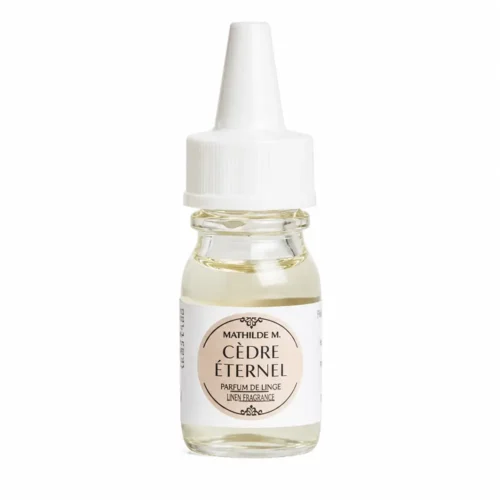 Superconcentrado Mathilde M Cèdre Éternel de 10 ml en un frasco de cristal transparente, con un líquido de color amarillo claro y un tapón dosificador blanco.