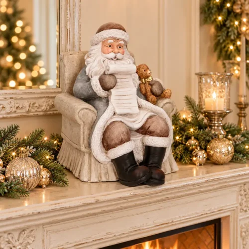 Babbo Natale in resina su poltrona avorio con orsetto H35 cm